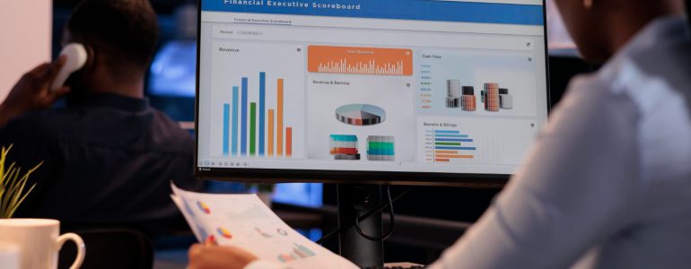 Office Employee Analyzing Business Charts Computer Documents Looking Online Research Data Create Presentation Working With Information Report Statistics Pc