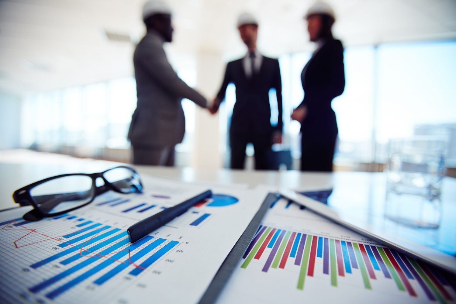 business-objects-with-executives-discussing-blueprint-meeting