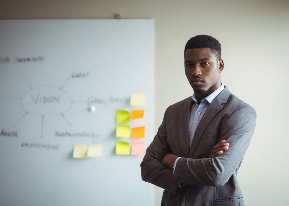 Businessman Standing With Arms Crossed Office