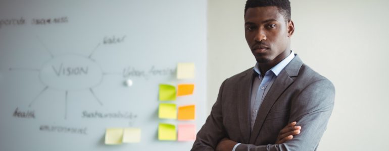 Businessman Standing With Arms Crossed Office