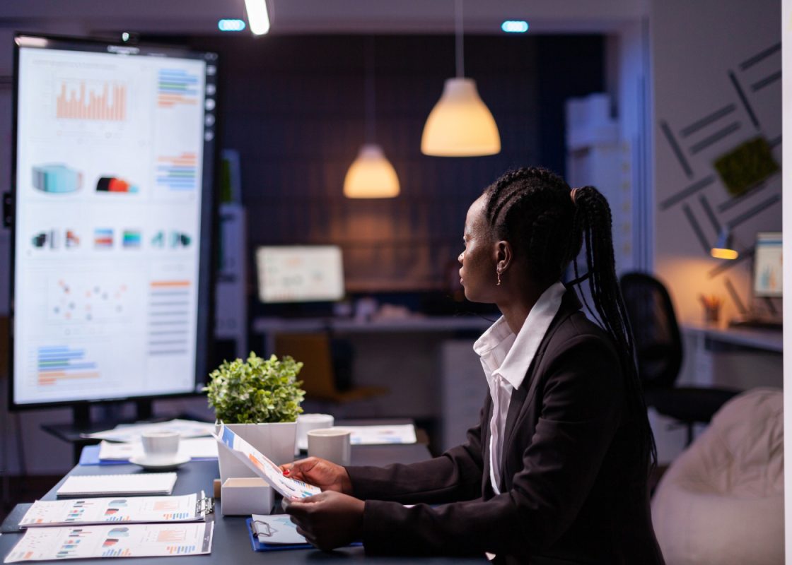 Focused Workaholic African American Businesswoman Working Company Financial Charts Presentation