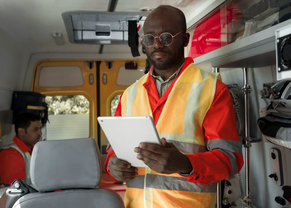 Side View Paramedic Holding Tablet