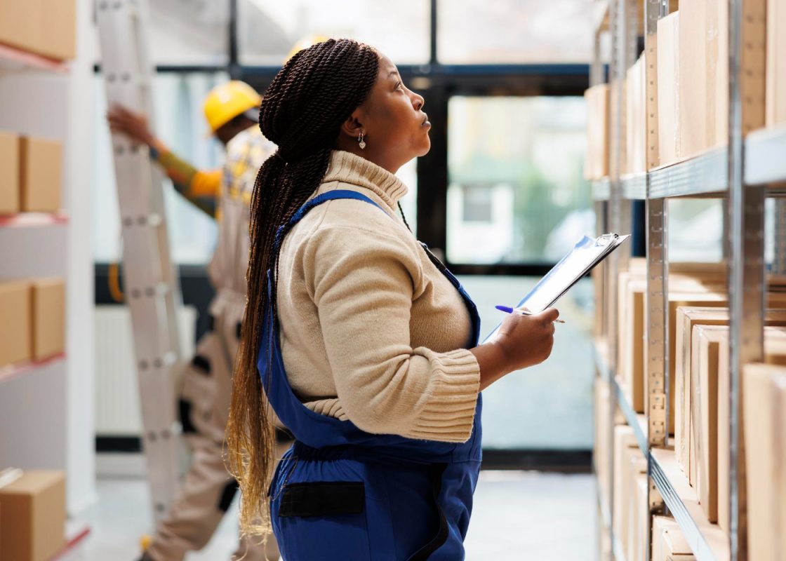 Warehouse Supervisor Looking Parcels Taking Notes